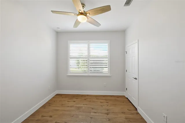 a bathroom with a granite countertop sink a mirror a toilet and shower
