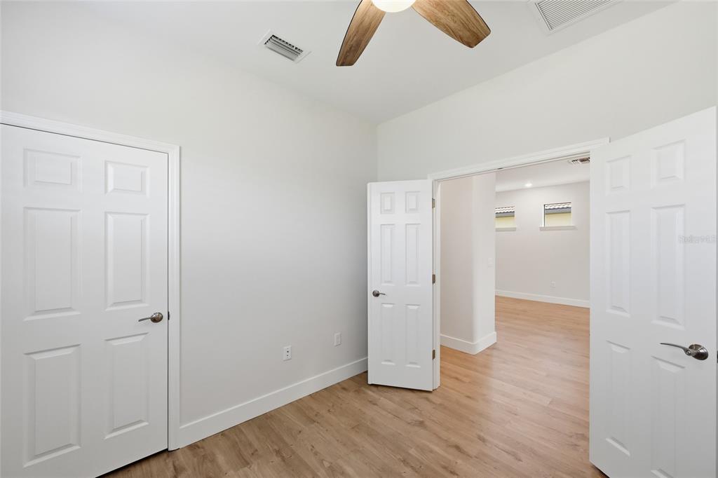 17029 Hampton Falls Terrace Lakewood Ranch, FL 34202 - Photo 30 of 56 an empty room with wooden floor and closet