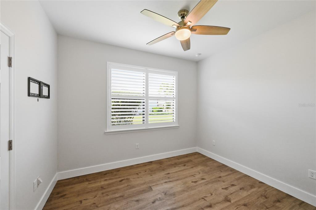 17029 Hampton Falls Terrace Lakewood Ranch, FL 34202 - Photo 31 of 56 an empty room with a window and a fan