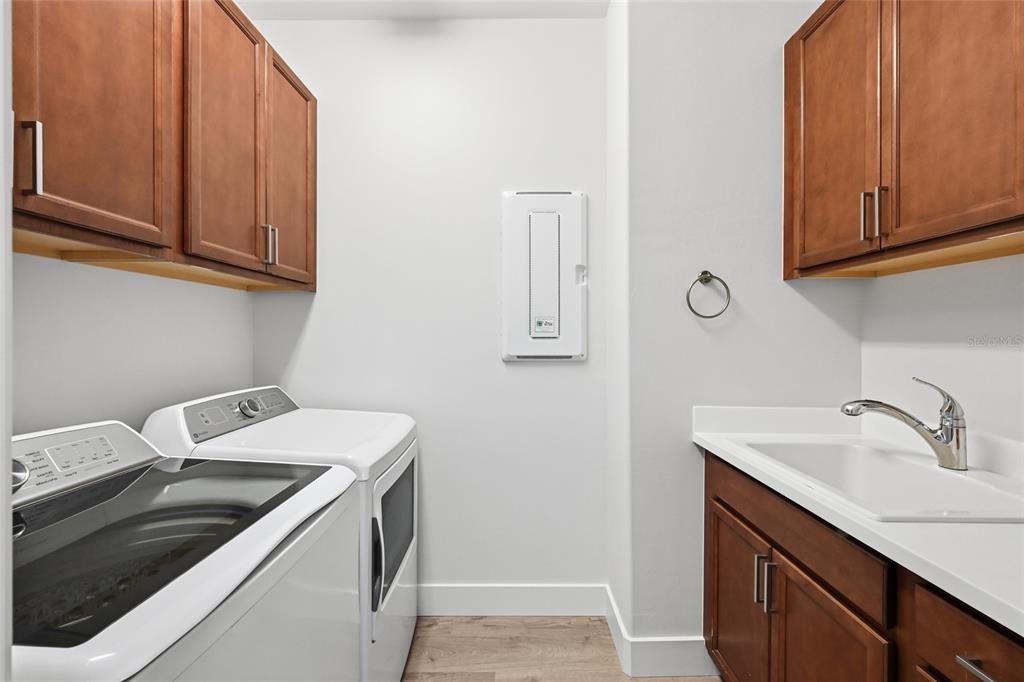 17029 Hampton Falls Terrace Lakewood Ranch, FL 34202 - Photo 41 of 56 a utility room with a sink washer and dryer