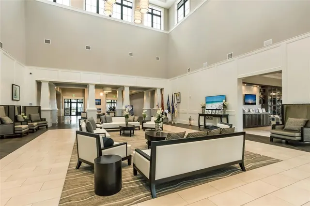 a view of a roof deck with couches and potted plants