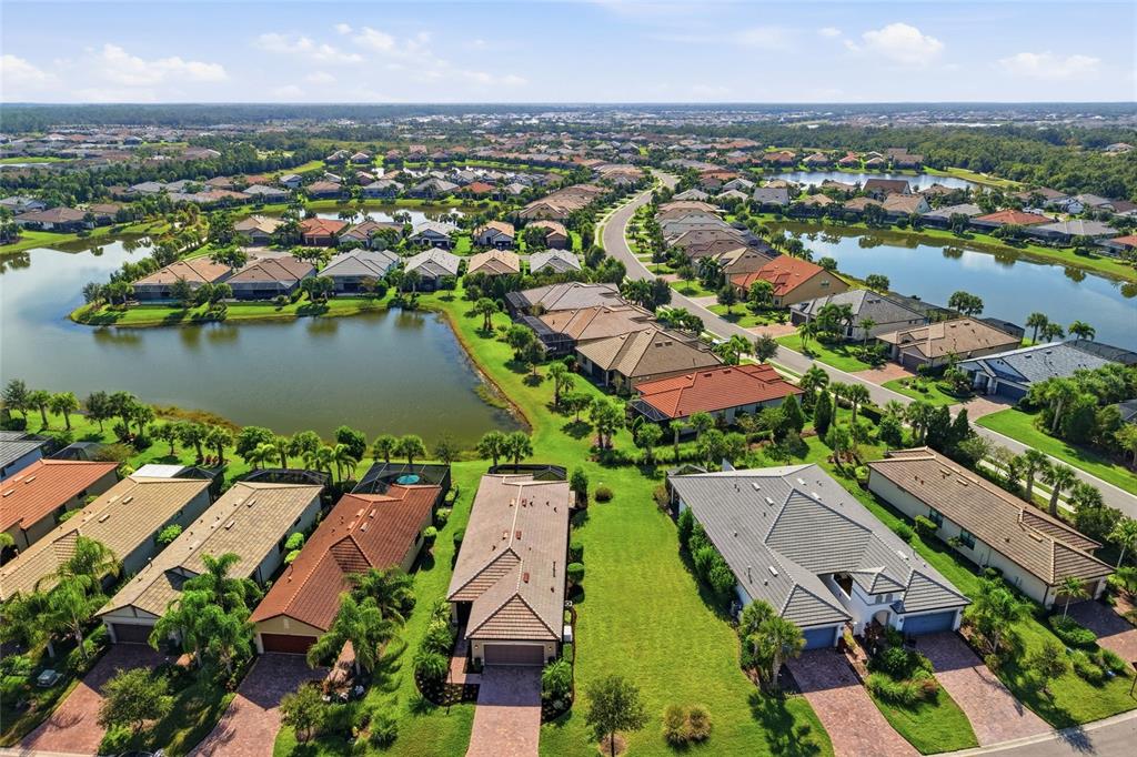 17029 Hampton Falls Terrace Lakewood Ranch, FL 34202 - Photo 6 of 56 an aerial view of residential houses with outdoor space and lake view