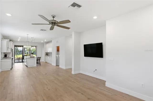 a view of empty room with wooden floor