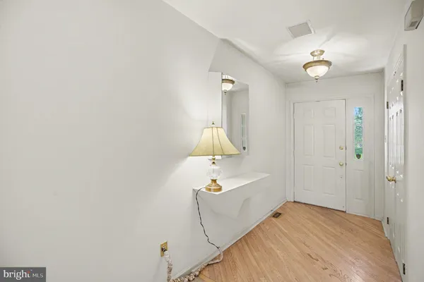 a bedroom with a bed and a chandelier fan