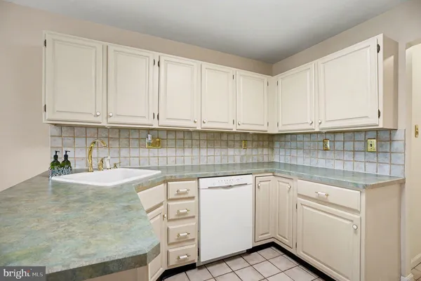 a kitchen with white cabinets