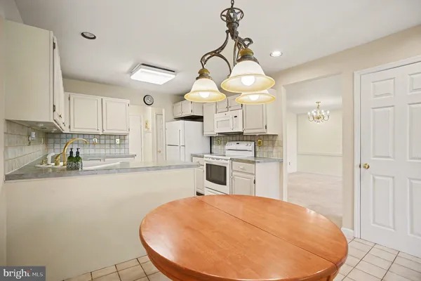 a kitchen with a refrigerator a stove a sink and cabinets