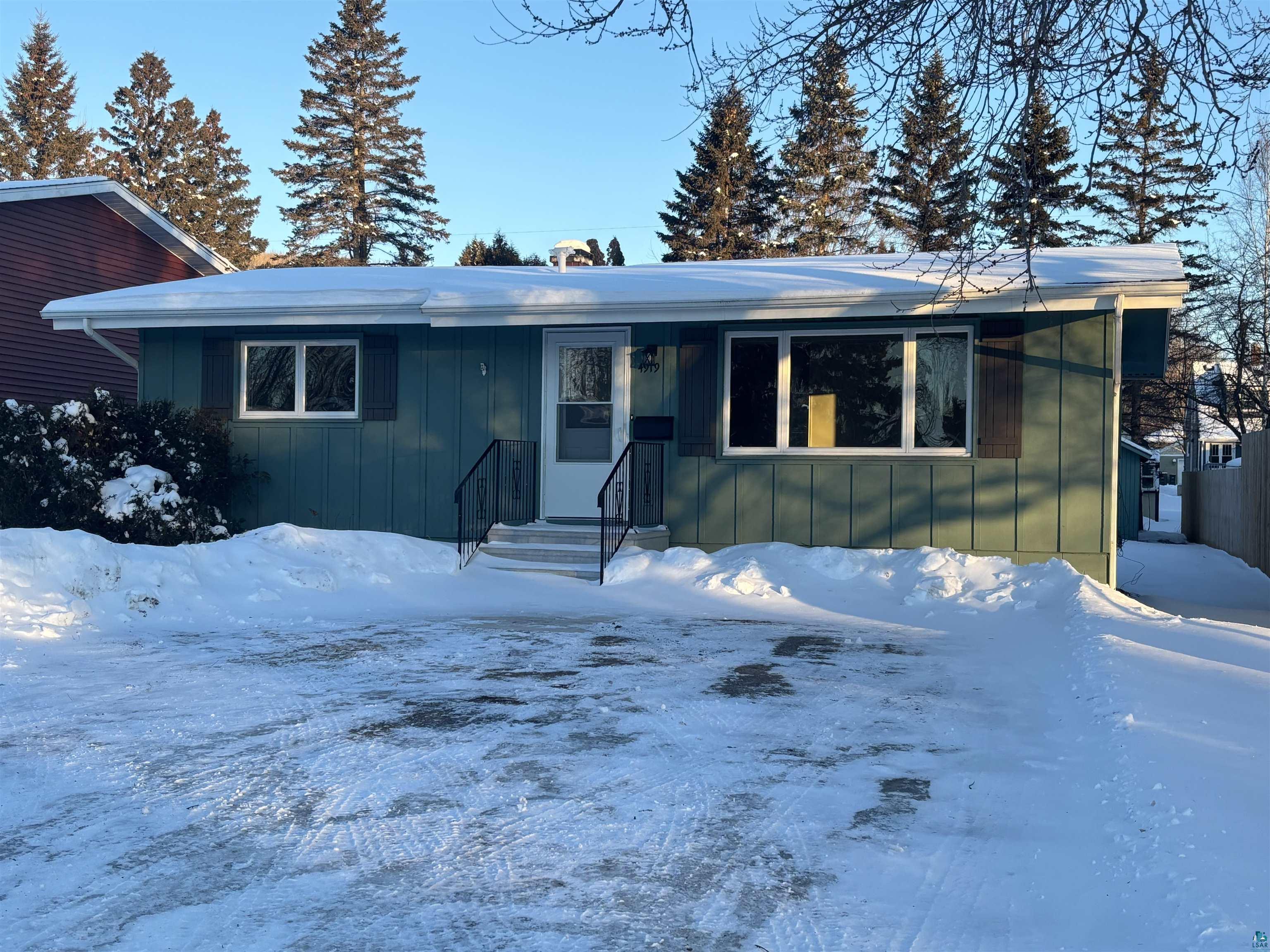 View of front of house featuring board and batten siding