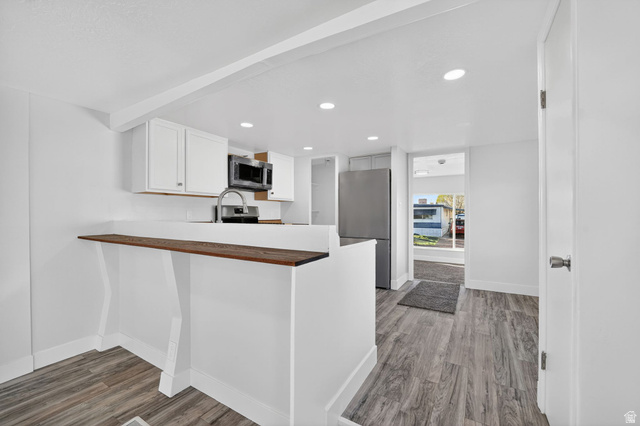 2491 Highway 89, Unit 523 Pleasant View, UT 84404 - Photo 9 of 31 UPDATED Kitchen with new stainless steel appliances, light wood-style floors, a peninsula, recessed lighting, and white cabinets