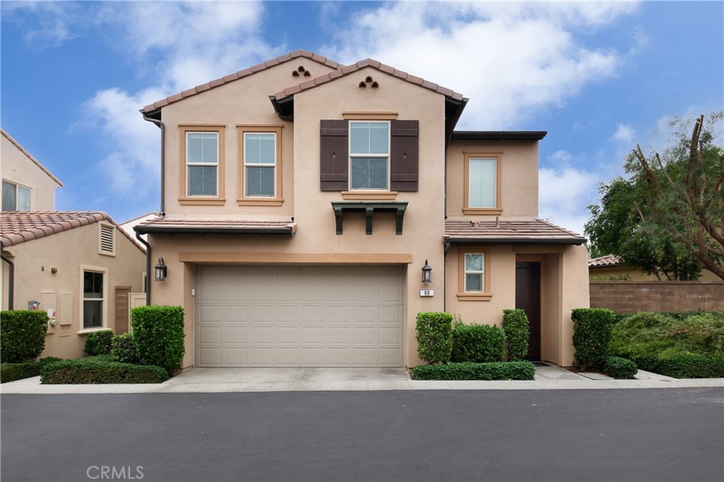 a front view of a house with garage and yard