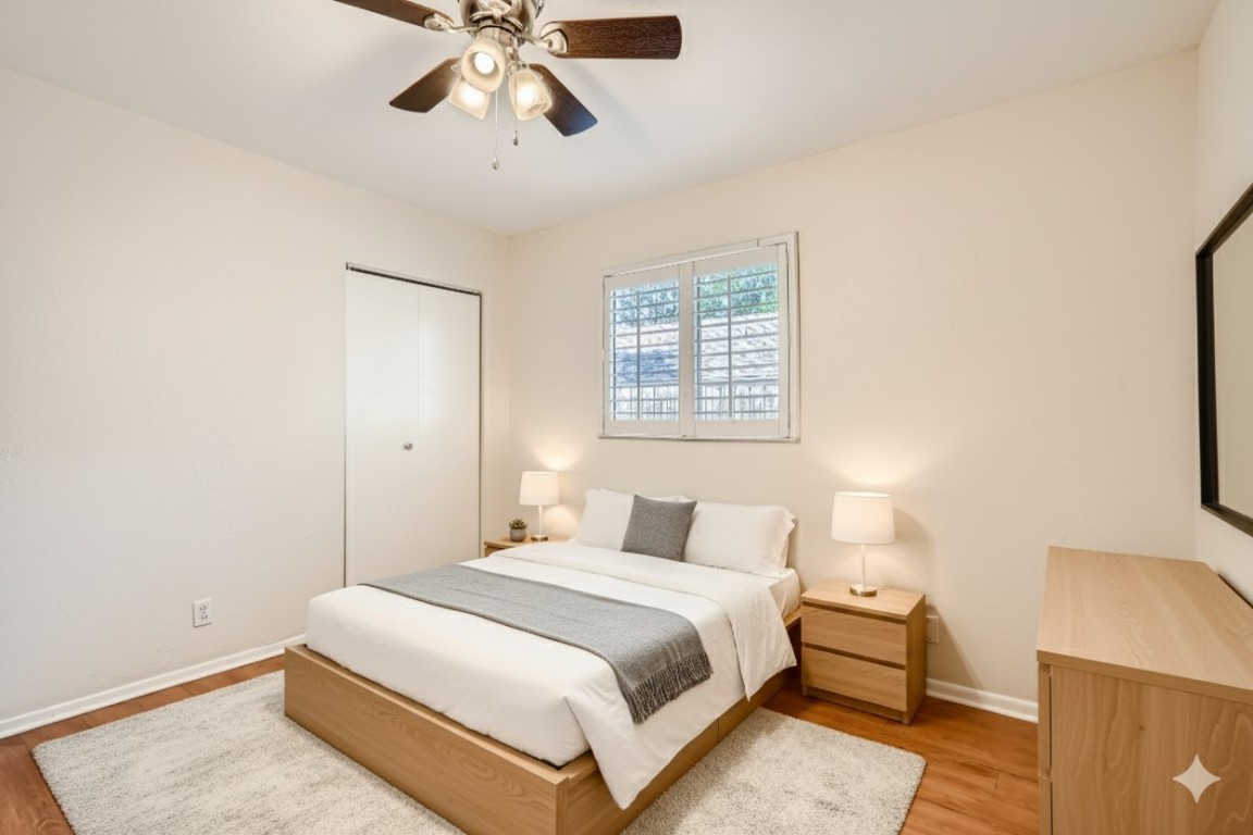 2712 Parker Lane, Unit A Austin, TX 78741 - Photo 3 of 13 a bedroom with a bed and a chandelier