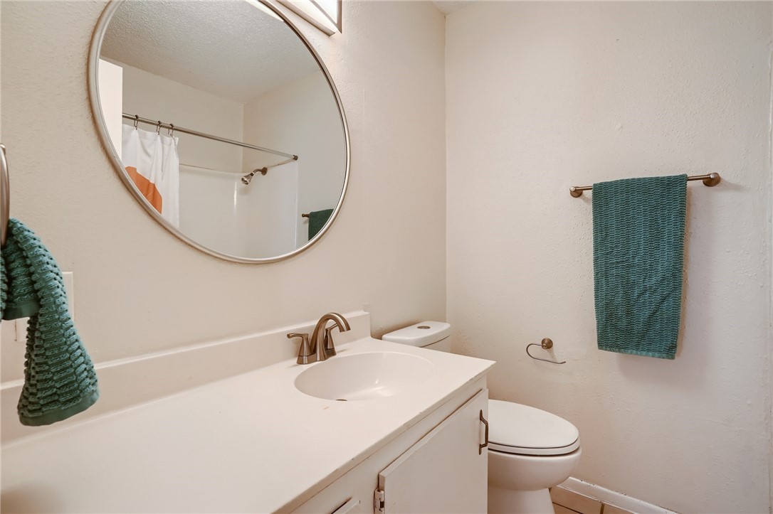 2712 Parker Lane, Unit A Austin, TX 78741 - Photo 8 of 13 a bathroom with a sink and a mirror