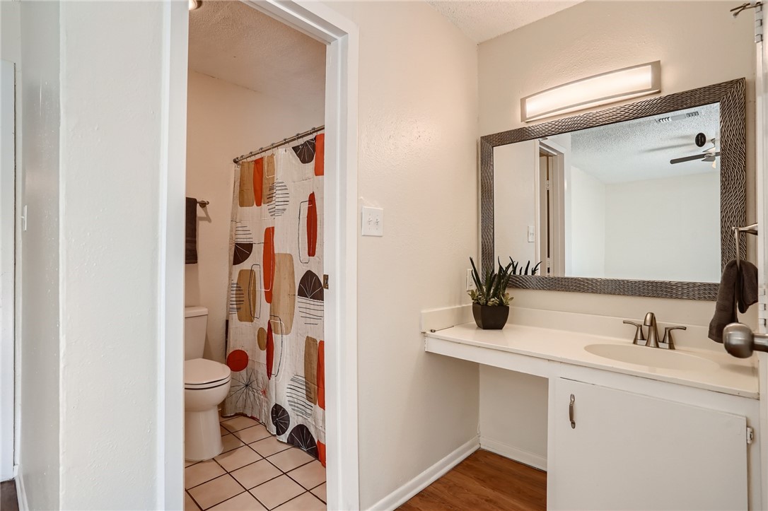 2712 Parker Lane, Unit A Austin, TX 78741 - Photo 9 of 13 a bathroom with a sink and a mirror