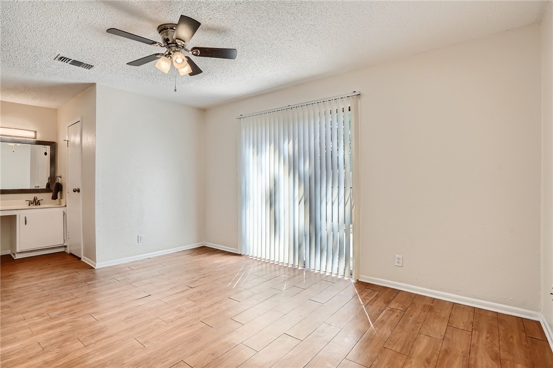 2712 Parker Lane, Unit A Austin, TX 78741 - Photo 10 of 13 an empty room with wooden floor and windows