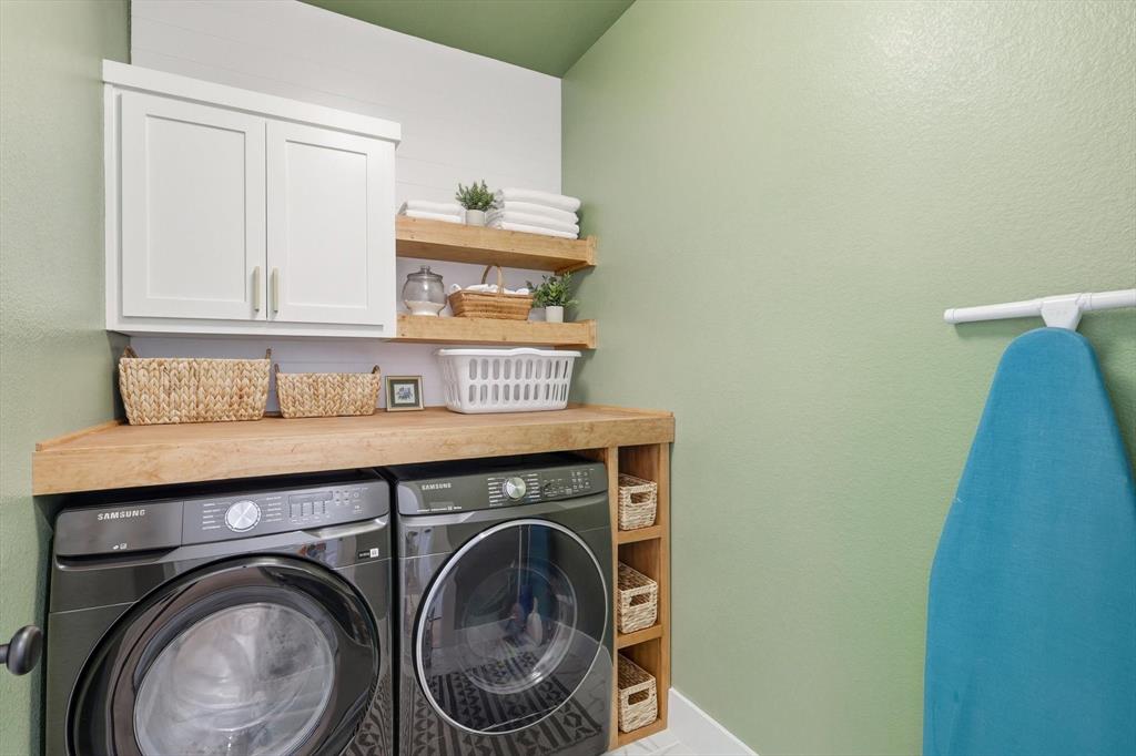 4608 Mount Vista Road Oak Point, TX 75068 - Photo 21 of 39 Dedicated laundry area featuring a wood-finish countertop, white cabinetry with brushed nickel hardware, and open wood-finish shelving