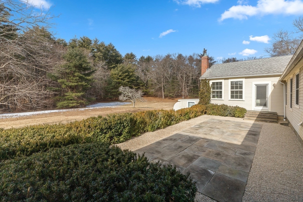 250 Cutler Road Hamilton, MA 01982 - Photo 27 of 34 a view of backyard of house with outdoor seating
