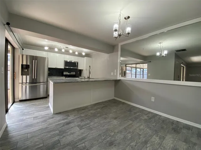 a view of a kitchen with a sink stove and cabinets