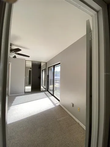a view of a big room with closet and windows