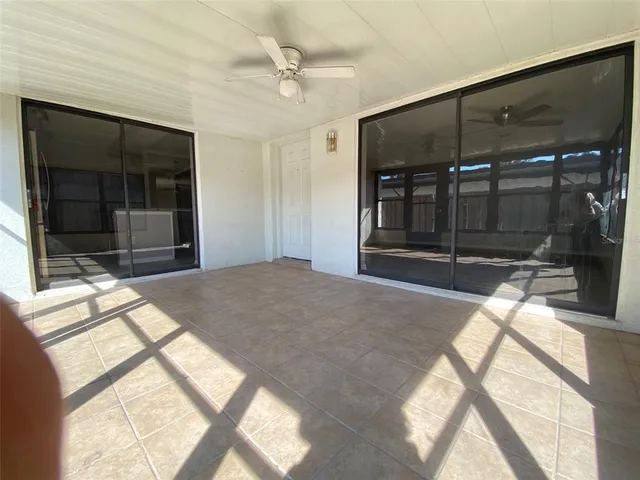 a bedroom with a bed and a large window with the outer view
