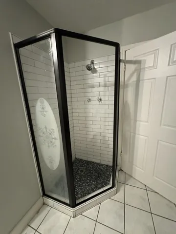 a bathroom with a glass shower door