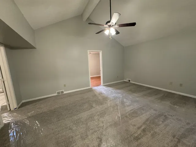a view of empty room with a fireplace