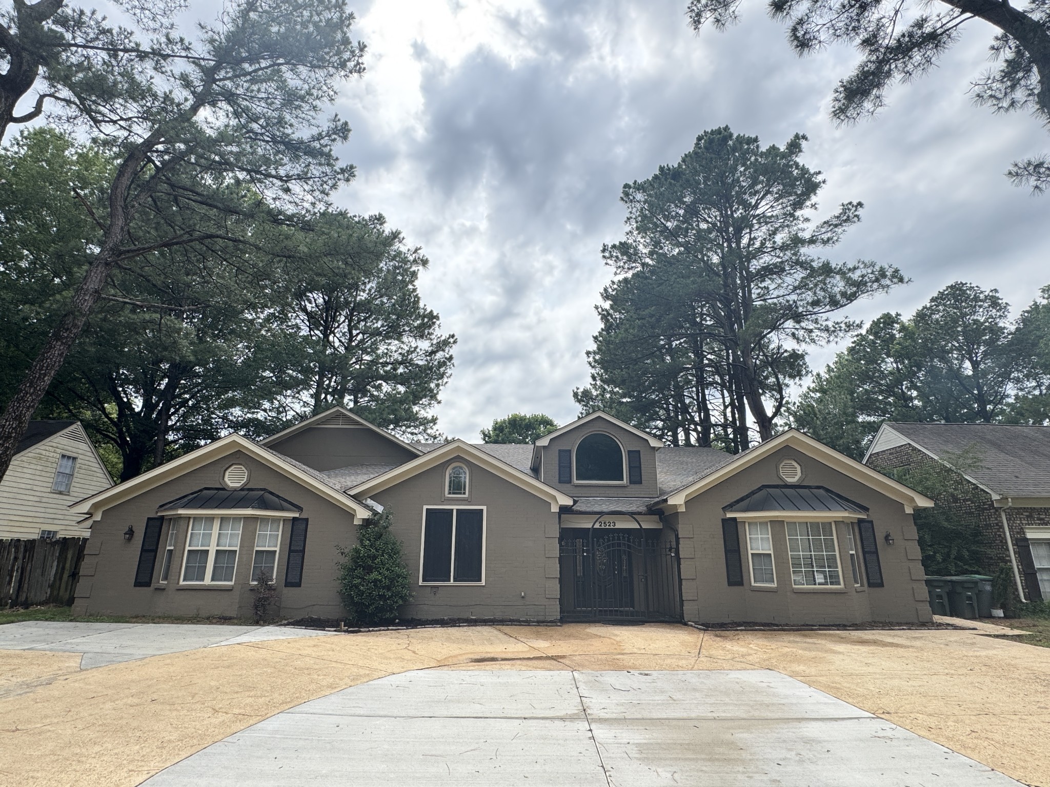 2523 Syon Drive Memphis, TN 38119 - Photo 6 of 54 a front view of a house with a garden and trees