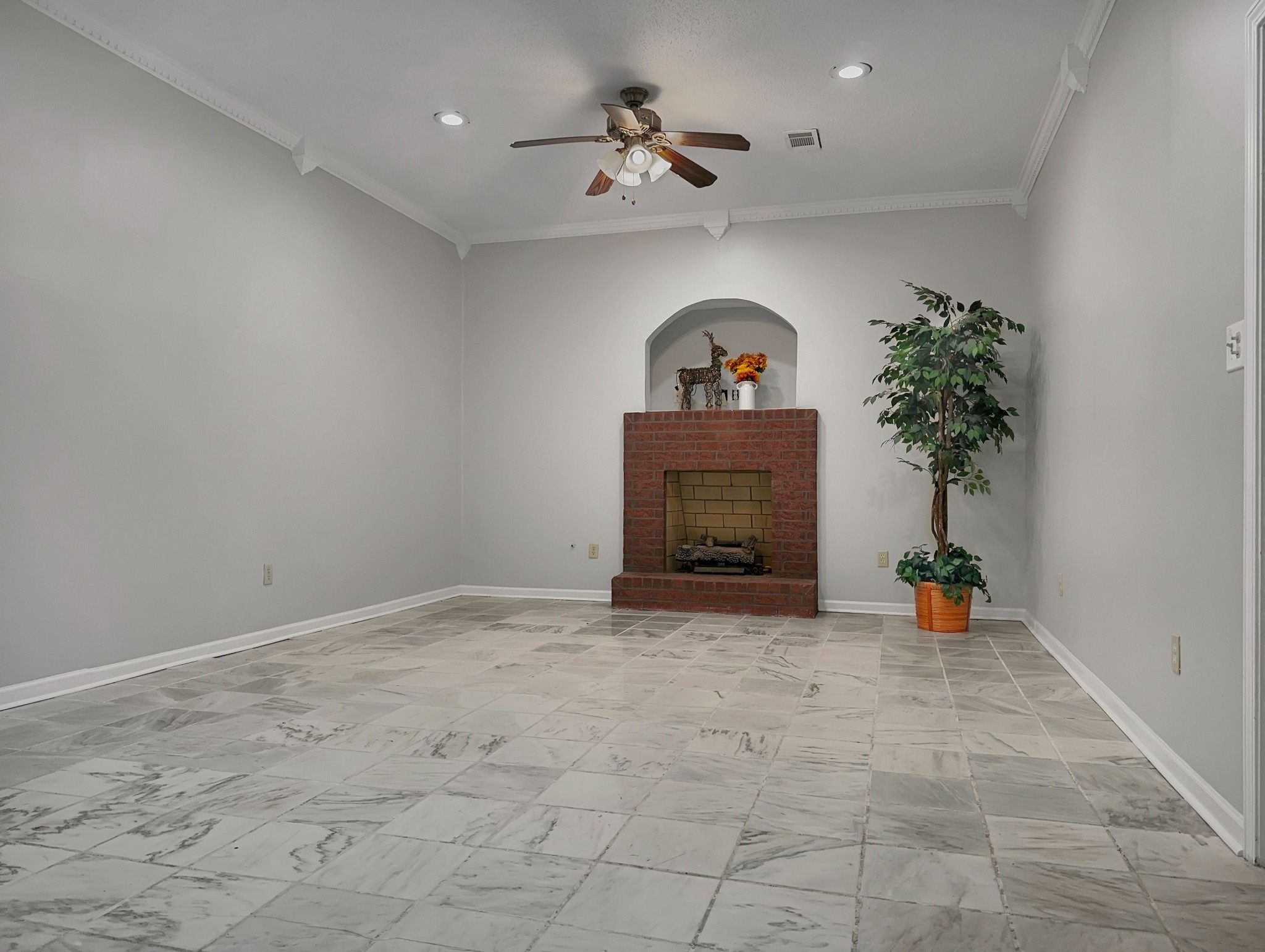 2523 Syon Drive Memphis, TN 38119 - Photo 7 of 54 an empty room with a fireplace and potted plant
