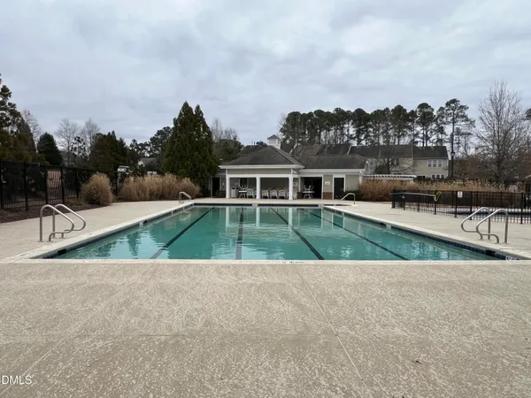 a view of an house with swimming pool and a yard