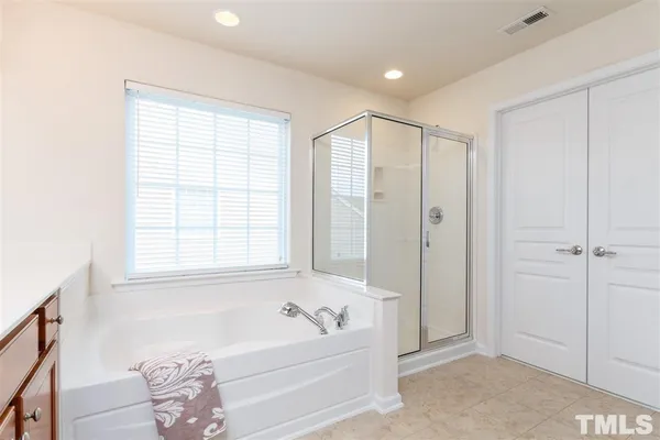 a bathroom with a bathtub and a shower