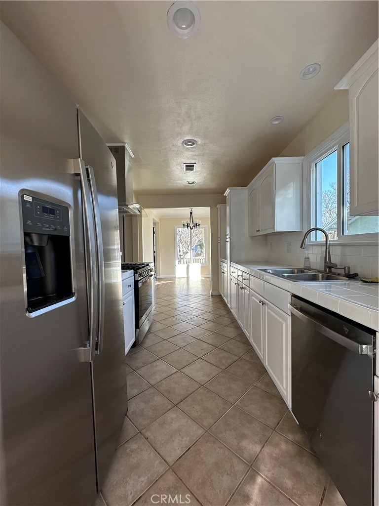6447 Balcom Avenue Reseda, CA 91335 - Photo 20 of 49 a large kitchen with cabinets and stainless steel appliances