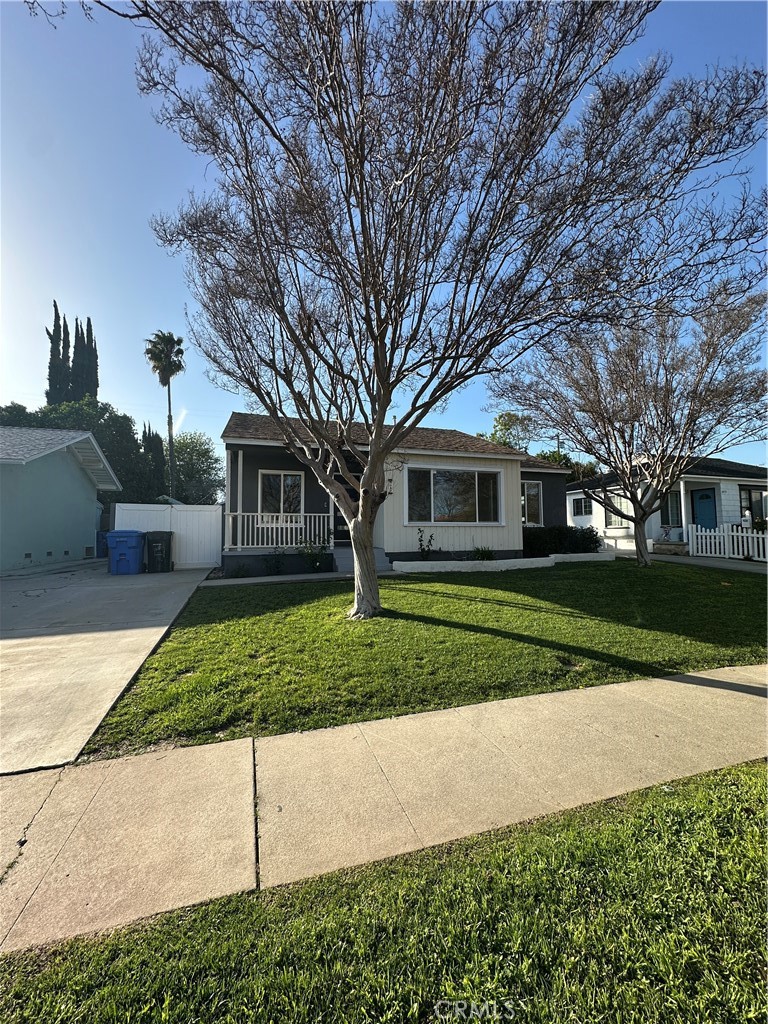 6447 Balcom Avenue Reseda, CA 91335 - Photo 3 of 49 a front view of a house with a yard and garage