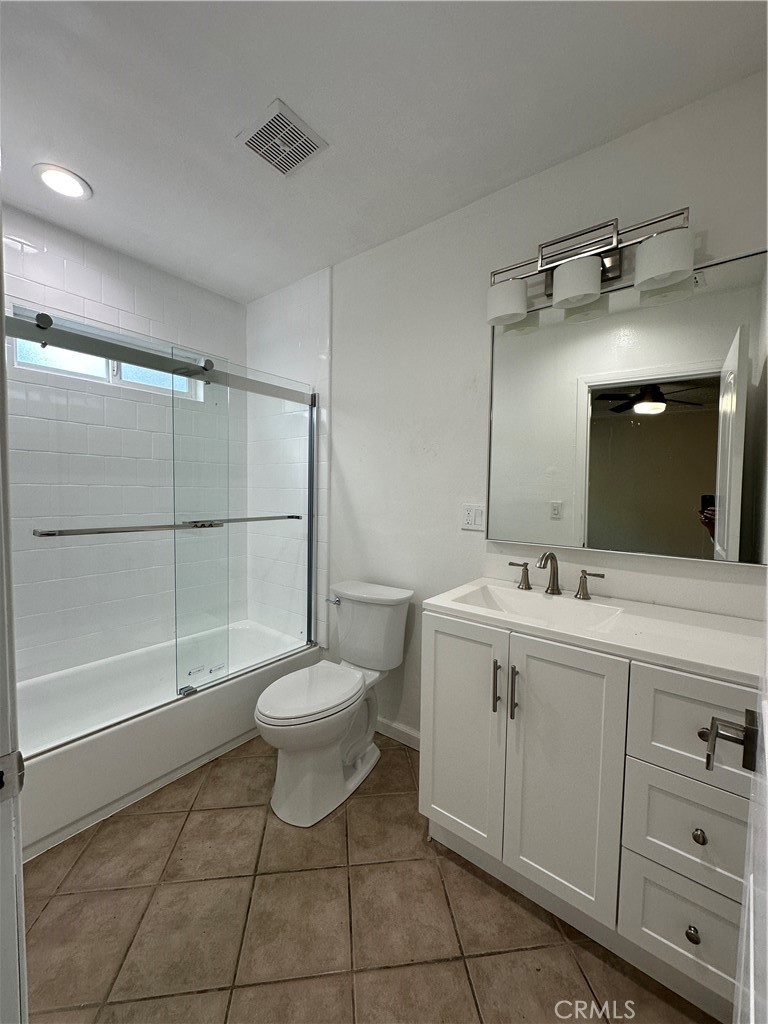 6447 Balcom Avenue Reseda, CA 91335 - Photo 35 of 49 a bathroom with a toilet sink and mirror