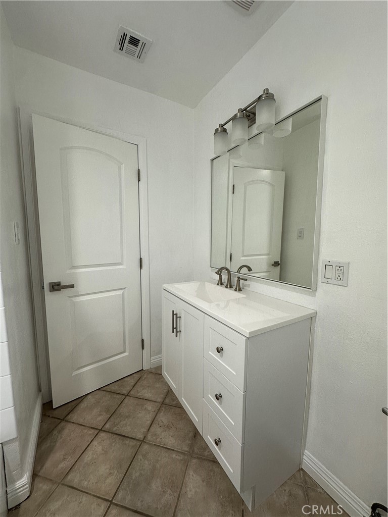 6447 Balcom Avenue Reseda, CA 91335 - Photo 43 of 49 a bathroom with a granite countertop sink mirror and