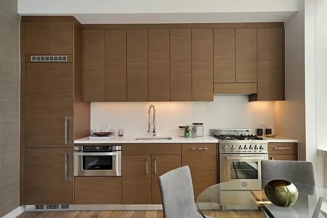 a kitchen with a sink cabinets and appliances