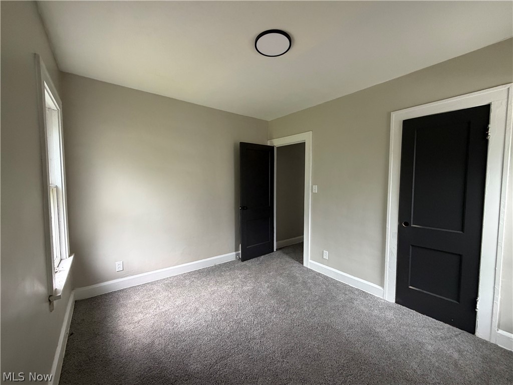 15317 Shiloh Road Cleveland, OH 44110 - Photo 9 of 29 Neutral-toned room featuring grey carpet flooring and white trim