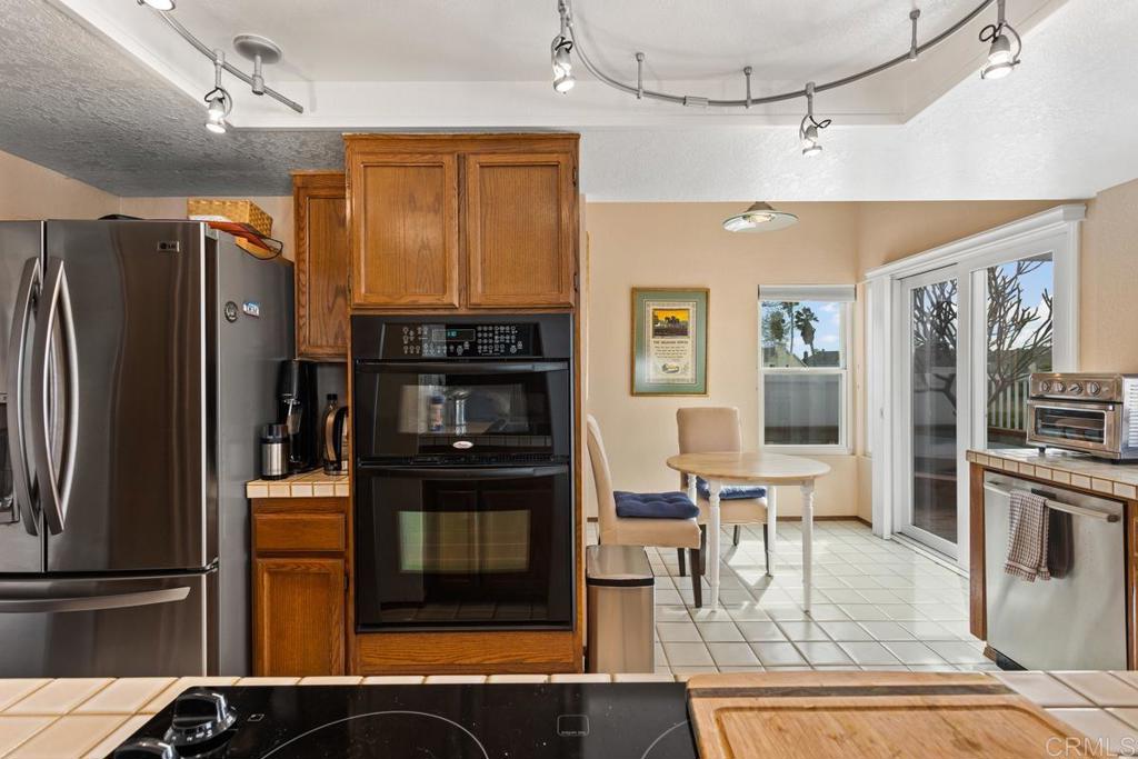1570 Pacific Ranch Drive Encinitas, CA 92024 - Photo 12 of 35 a kitchen with stainless steel appliances granite countertop a refrigerator and a stove