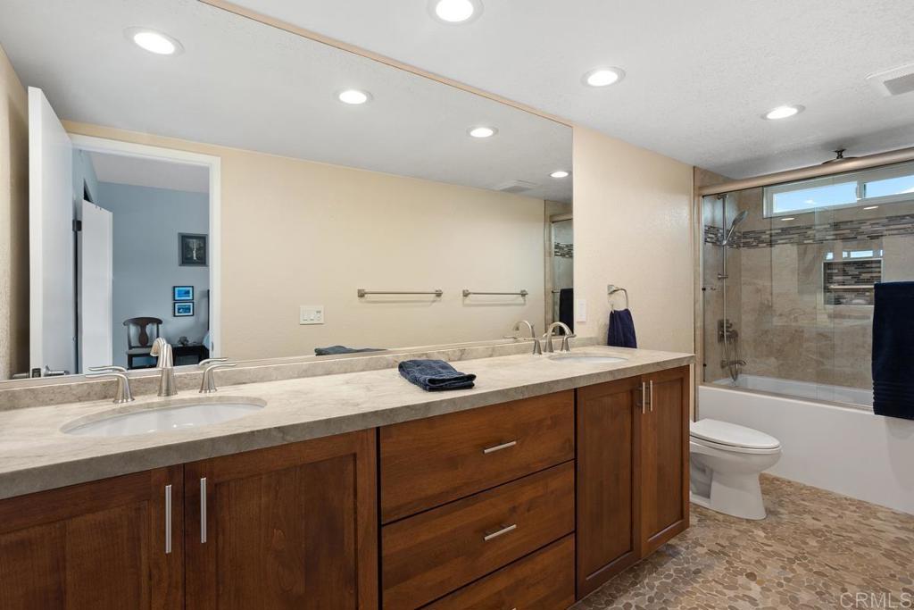 1570 Pacific Ranch Drive Encinitas, CA 92024 - Photo 19 of 35 a bathroom with a granite countertop sink mirror and toilet
