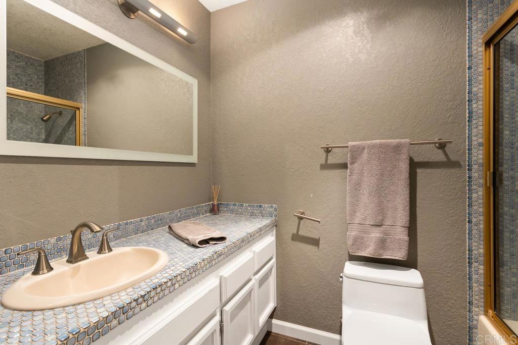 1570 Pacific Ranch Drive Encinitas, CA 92024 - Photo 21 of 35 a bathroom with a granite countertop sink and a mirror