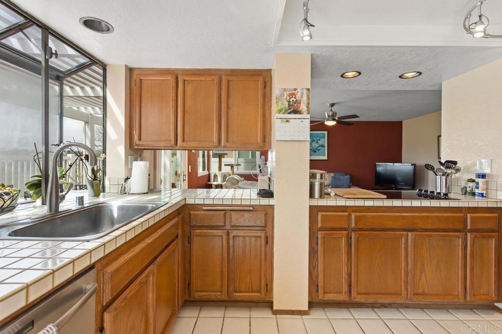 1570 Pacific Ranch Drive Encinitas, CA 92024 - Photo 9 of 35 a kitchen with stainless steel appliances granite countertop a sink and cabinets