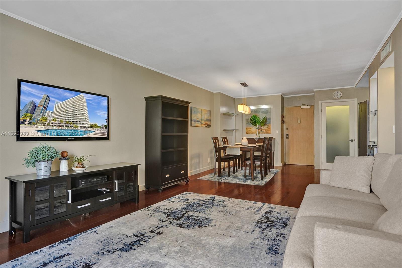 200 Southeast 15th Road, Unit 6I Miami, FL 33129 - Photo 11 of 50 a living room with furniture a dining table and painting on the wall