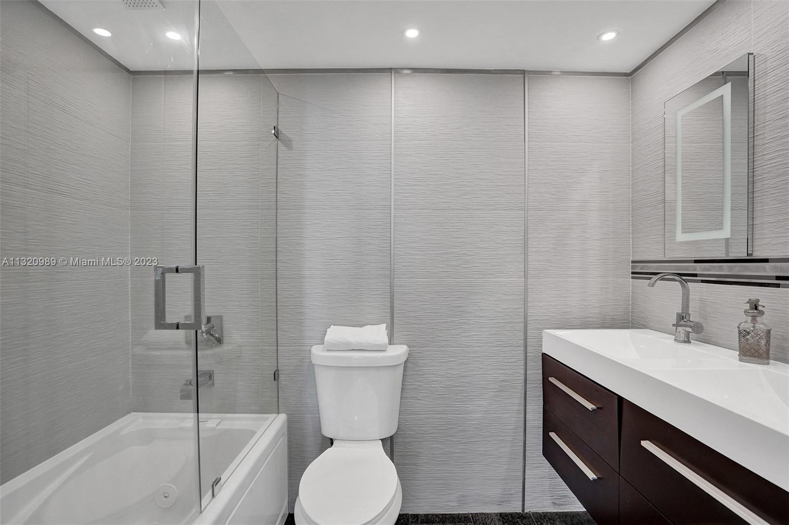 200 Southeast 15th Road, Unit 6I Miami, FL 33129 - Photo 15 of 50 a bathroom with a sink a toilet and shower