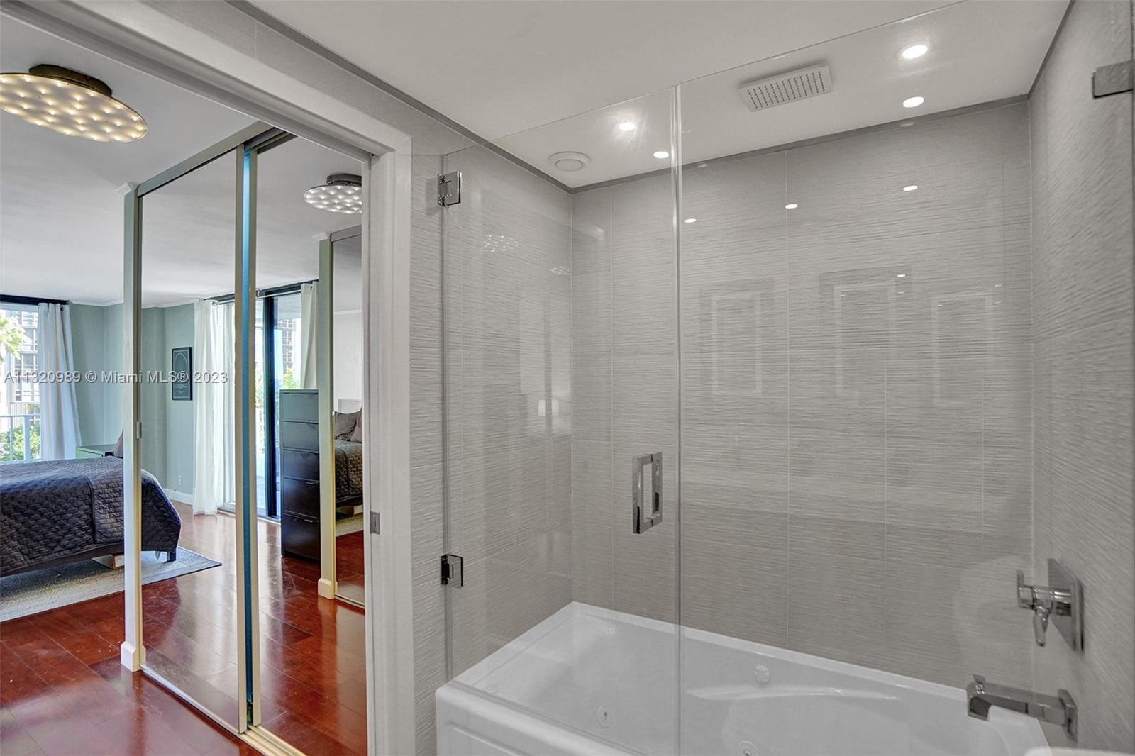 200 Southeast 15th Road, Unit 6I Miami, FL 33129 - Photo 17 of 50 a bathroom with a bathtub a toilet and a shower