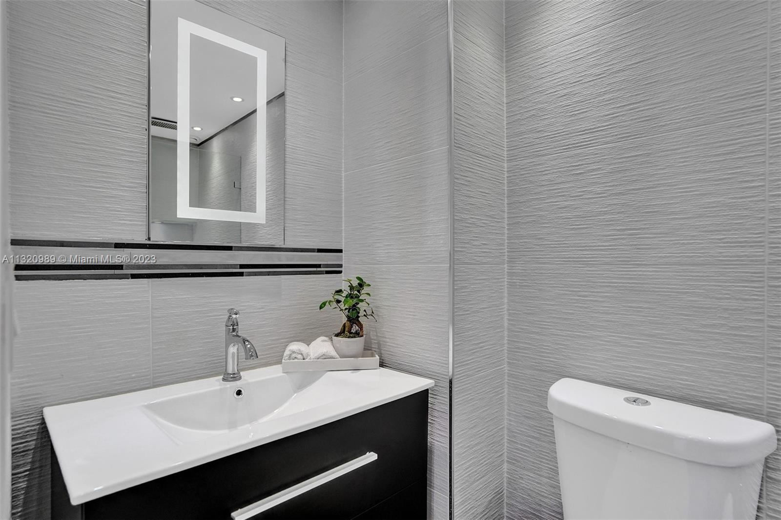 200 Southeast 15th Road, Unit 6I Miami, FL 33129 - Photo 23 of 50 a bathroom with a sink a toilet and mirror