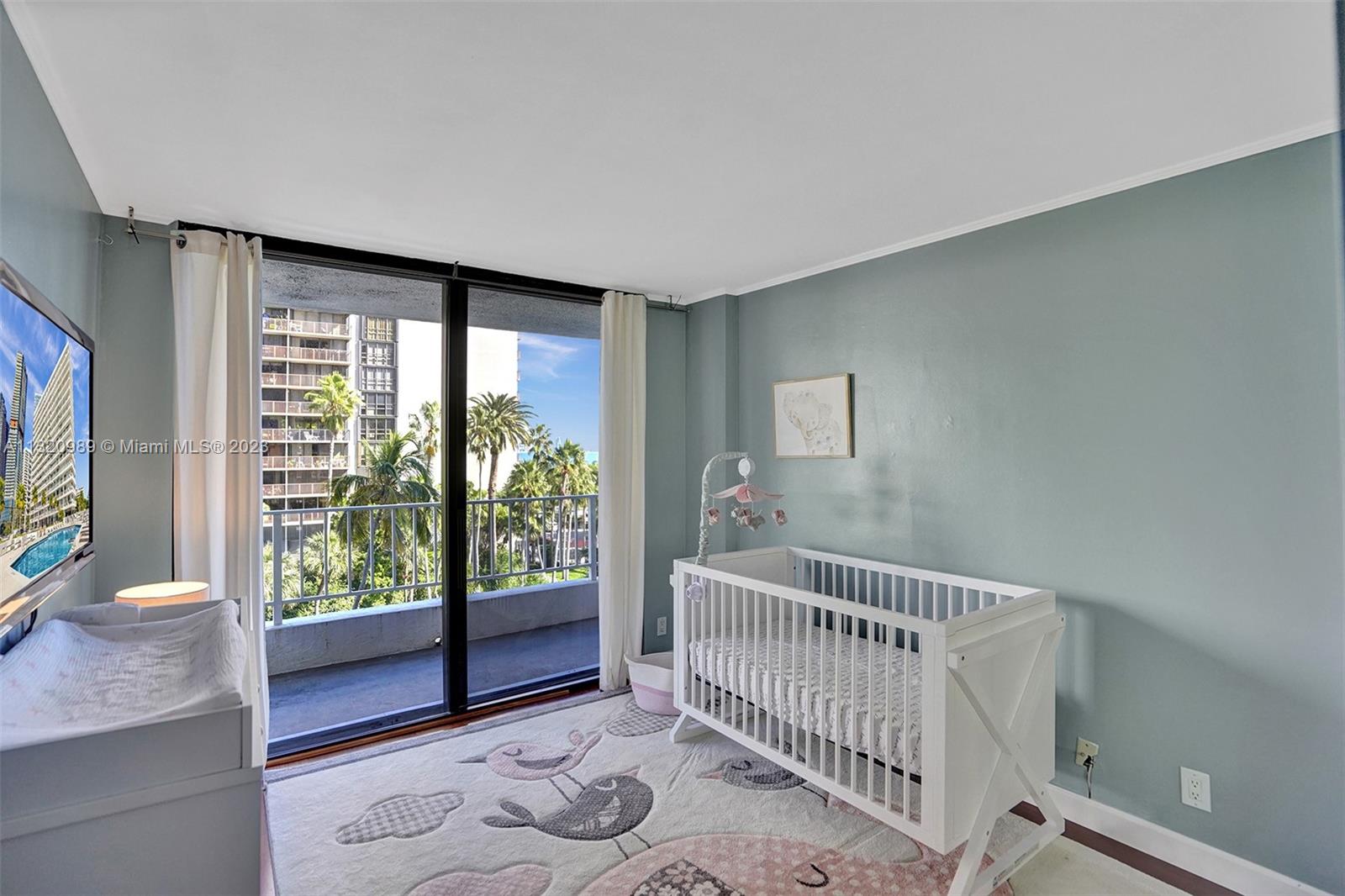 200 Southeast 15th Road, Unit 6I Miami, FL 33129 - Photo 25 of 50 a view of a bedroom with wooden floor and windows
