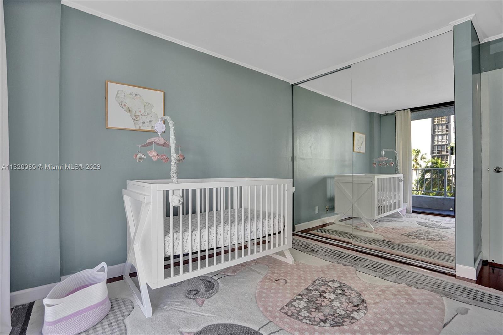 200 Southeast 15th Road, Unit 6I Miami, FL 33129 - Photo 26 of 50 a view of a bedroom with wooden floor and a rug