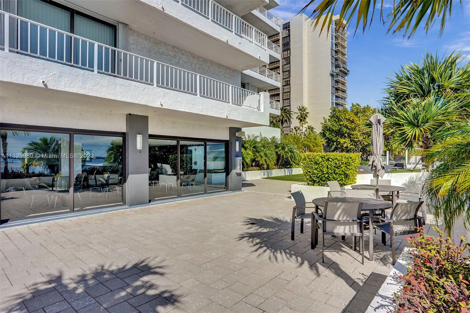 200 Southeast 15th Road, Unit 6I Miami, FL 33129 - Photo 43 of 50 a view of a patio with a table and chairs and potted plants