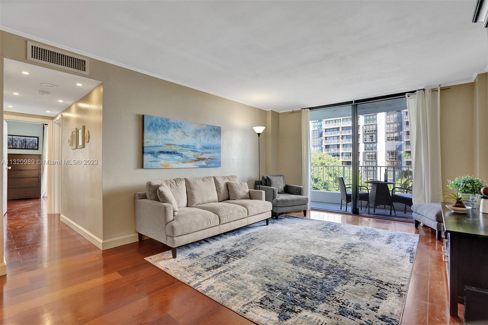 200 Southeast 15th Road, Unit 6I Miami, FL 33129 - Photo 6 of 50 a living room with furniture and large windows