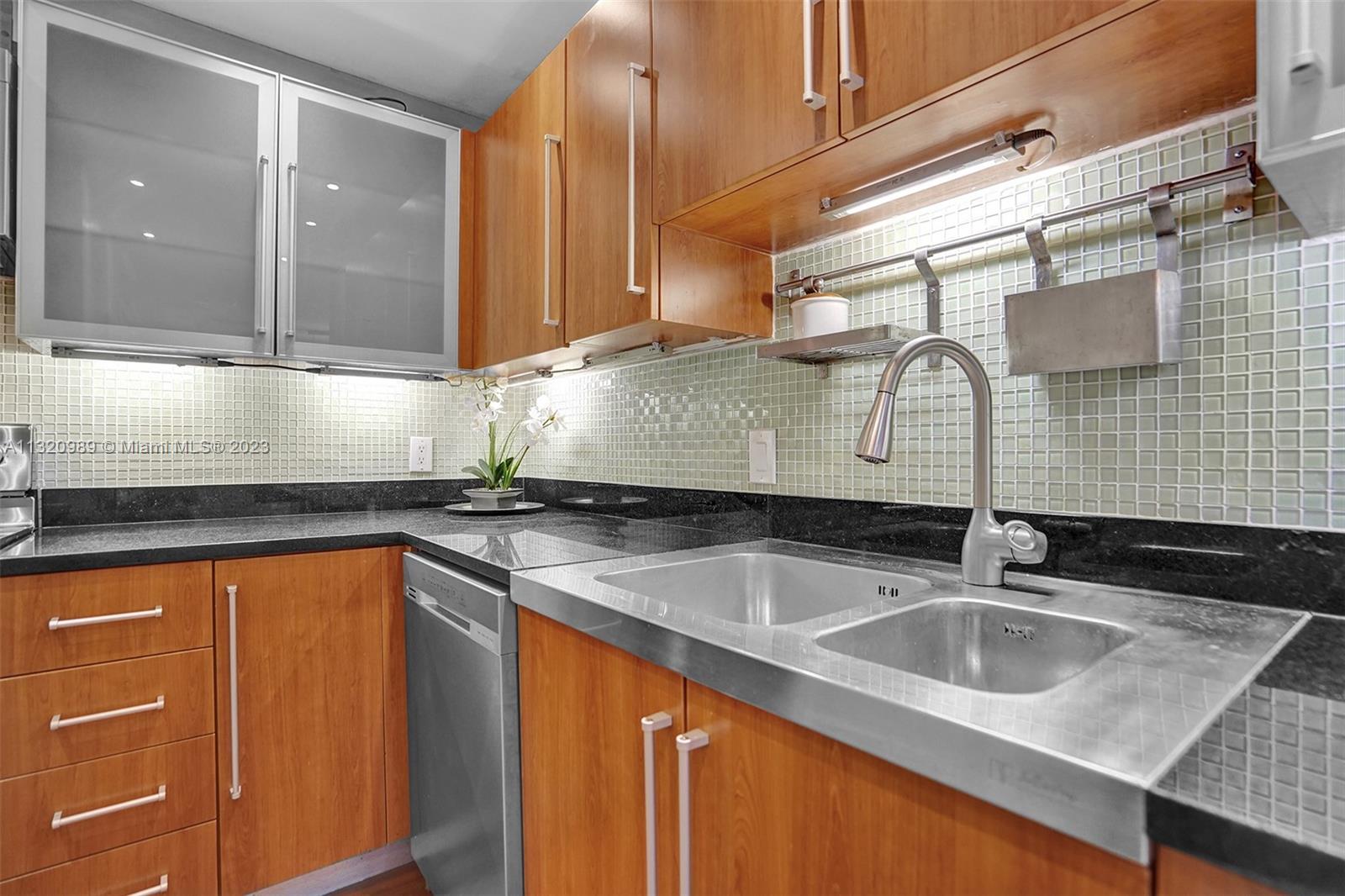 200 Southeast 15th Road, Unit 6I Miami, FL 33129 - Photo 9 of 50 a kitchen with stainless steel appliances granite countertop a sink and cabinets