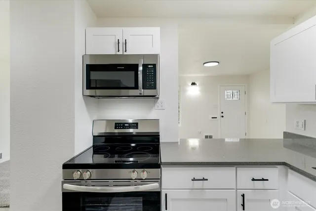 a kitchen with a stove and a microwave