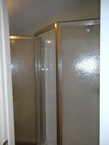 a bathroom with a glass shower door