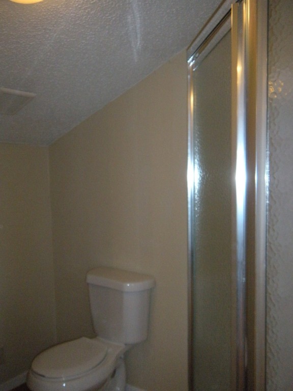303 West 35th Street, Unit 304 Austin, TX 78705 - Photo 12 of 13 a white toilet sitting next to a shower